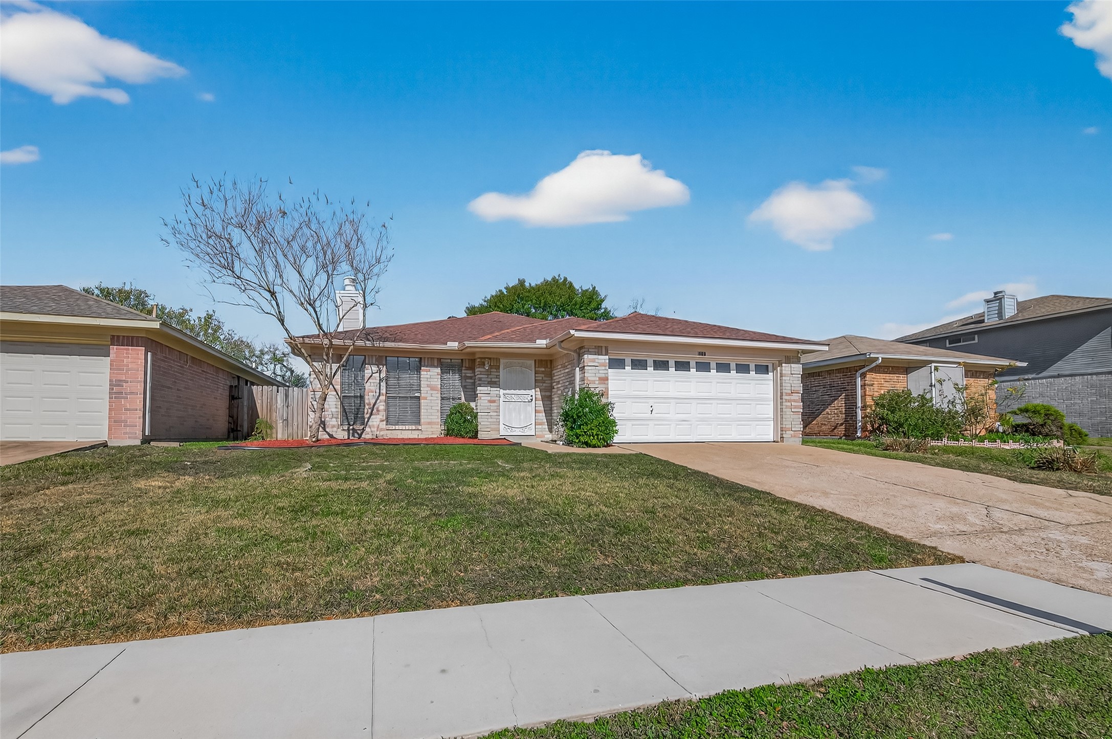 10810 Umber Court Houston, TX 77099 - Photo 2 of 43 Captures the home's complete profile, showcasing the manicured lawn and the wide sidewalk that frames the property.