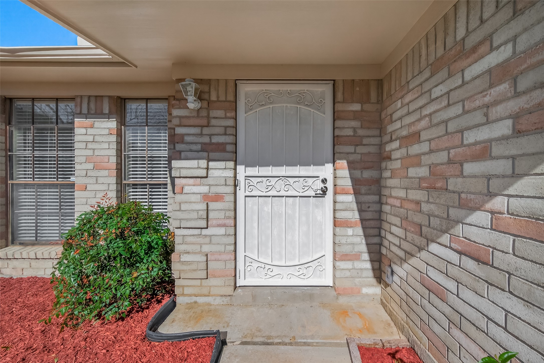 10810 Umber Court Houston, TX 77099 - Photo 3 of 43 Step up to an inviting entryway highlighted by a white door that complements the home's classic style. The entrance is tucked into a sturdy four-sided brick facade, overlooking a neatly manicured front garden. Large windows provide a glimpse of the home's open, airy feel while adding to the impressive curb appeal.