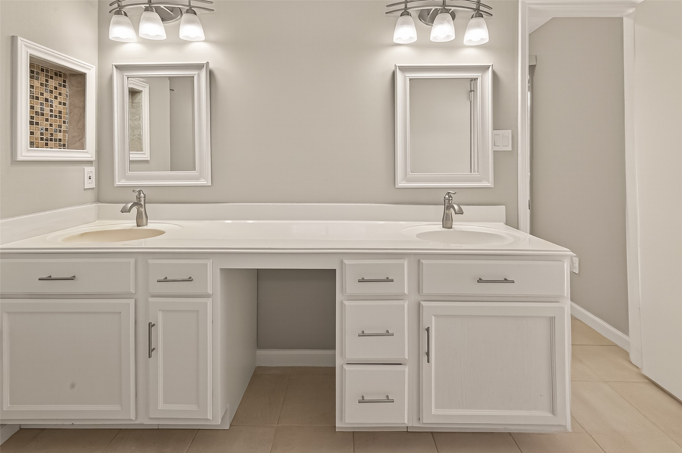 10810 Umber Court Houston, TX 77099 - Photo 32 of 43 Bright and modern bathroom featuring a double vanity with white cabinetry, two mirrors, and elegant light fixtures.
