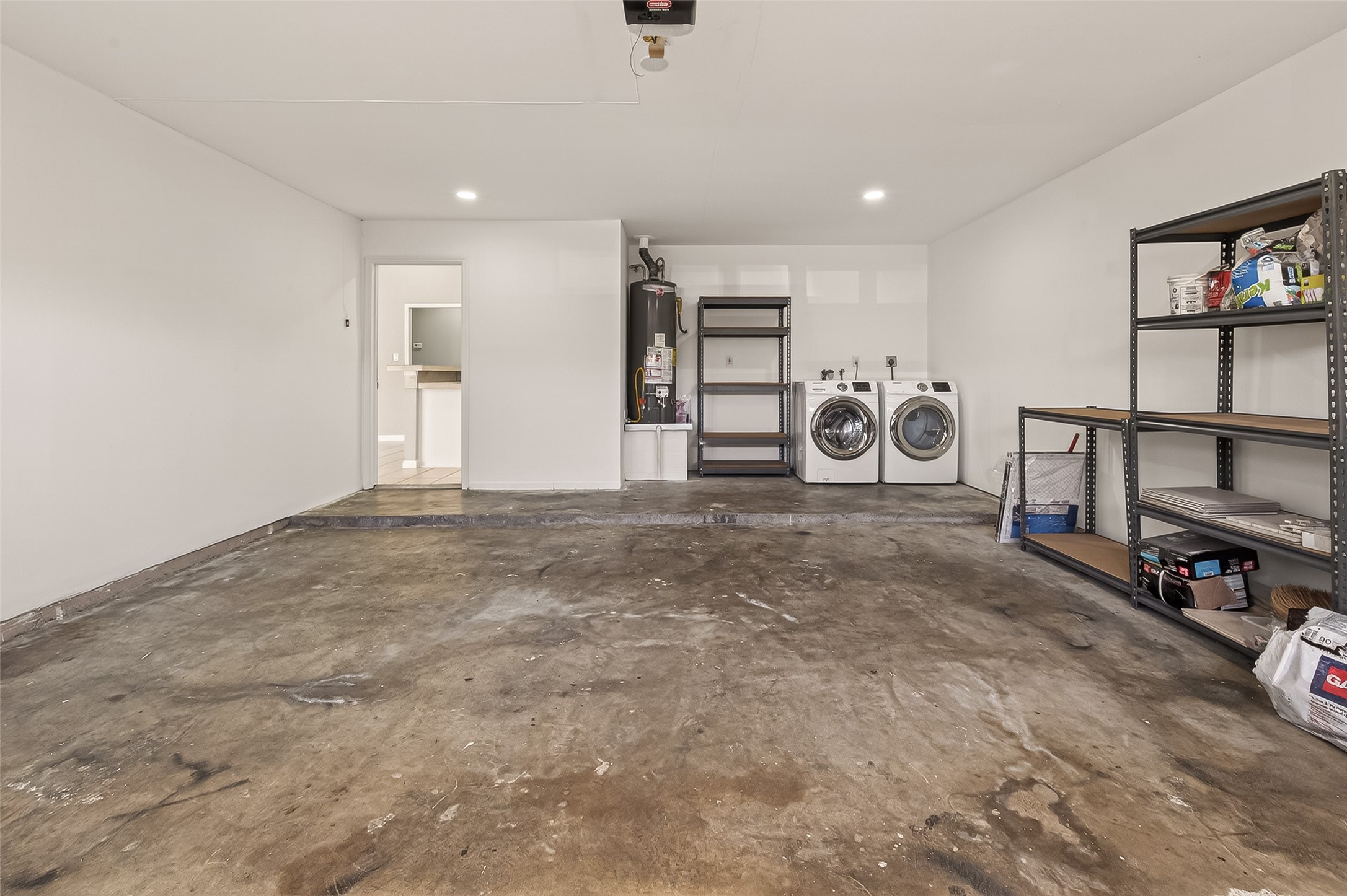 10810 Umber Court Houston, TX 77099 - Photo 35 of 43 This isn’t your typical garage—it’s a bright, multi-functional space featuring modern recessed lighting that makes the area feel clean and inviting. The seller is generously including the washer and dryer with the home, providing a truly move-in-ready experience from day one.