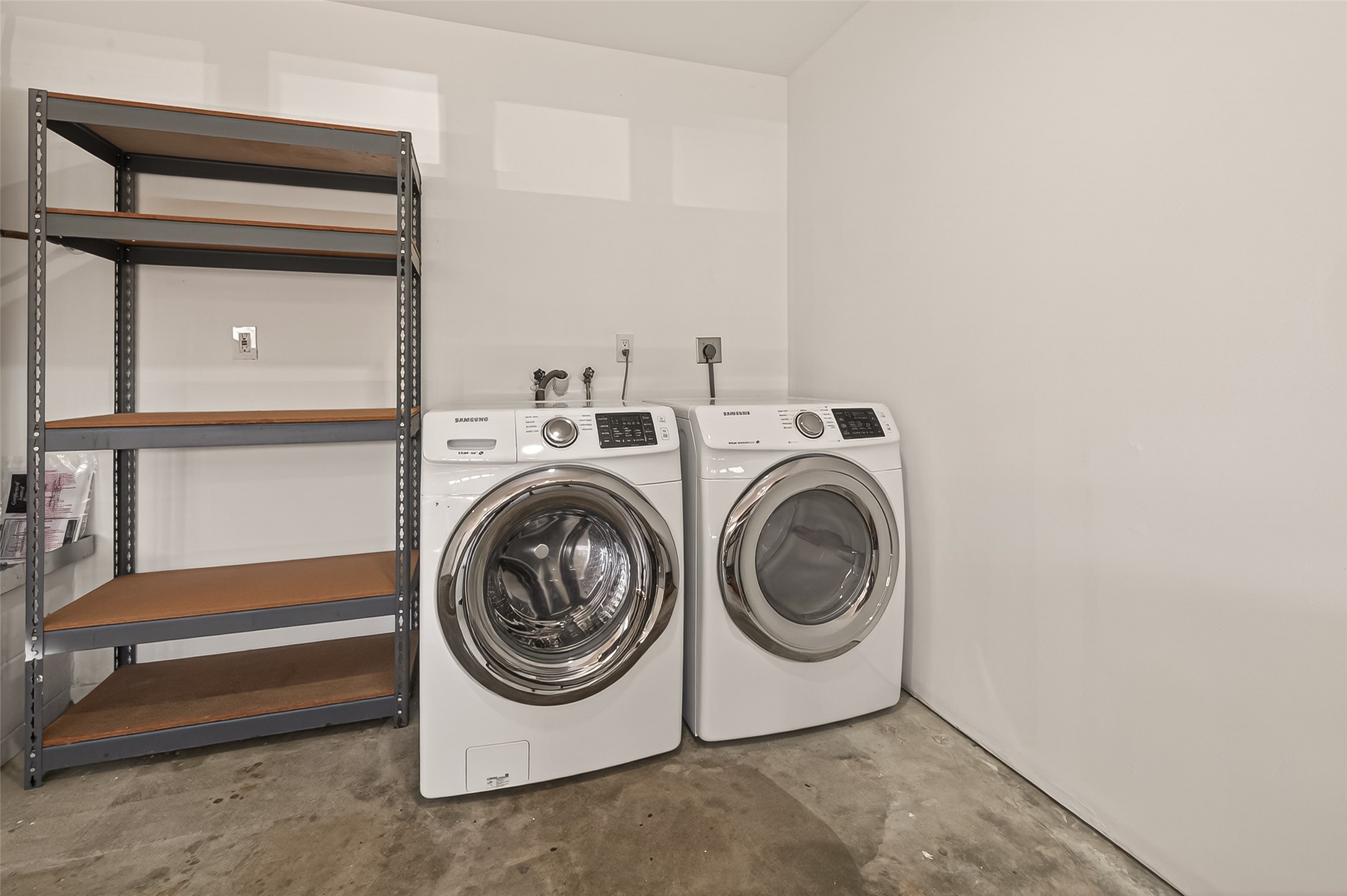 10810 Umber Court Houston, TX 77099 - Photo 36 of 43 With its fresh paint and updated lighting, this spacious two-car garage offers a polished look that matches the rest of the home’s interior. The garage features a convenient washer and dryer area, a new water heater, and shelving throughout the garage that will convey with the home, providing excellent storage and organization. Durable concrete flooring and generous space make this garage both functional and versatile.