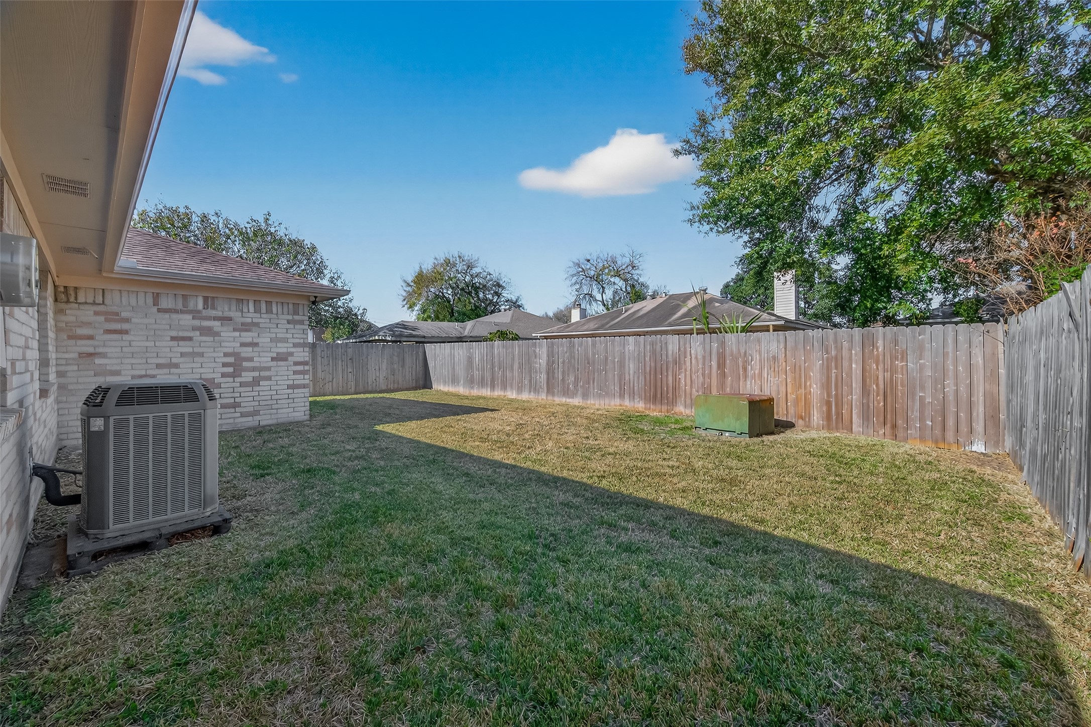 10810 Umber Court Houston, TX 77099 - Photo 39 of 43 This private backyard is a true retreat, steps into a lush, green lawn perfect for pets or play. Surrounded by a tall privacy fence it’s an ideal setting for quiet afternoons or weekend fun.