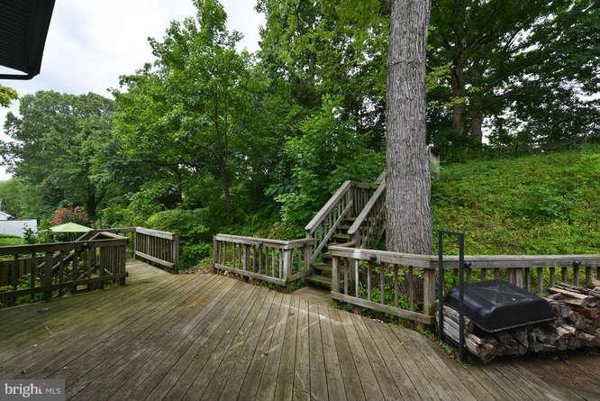 5918 Atteentee Road Springfield, VA 22150 - Photo 24 of 25 a view of a deck with couches wooden floor and fence