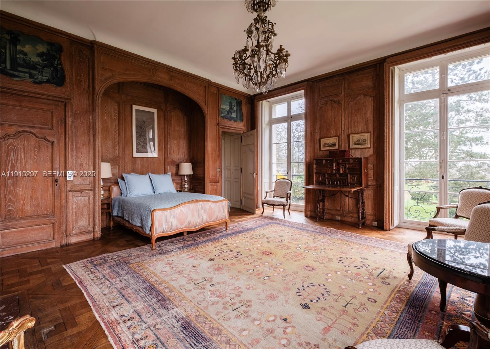 53 Rte De Saint-Germain El Indio, IDF 78860 - Photo 9 of 14 a bedroom with a large bed and a chandelier