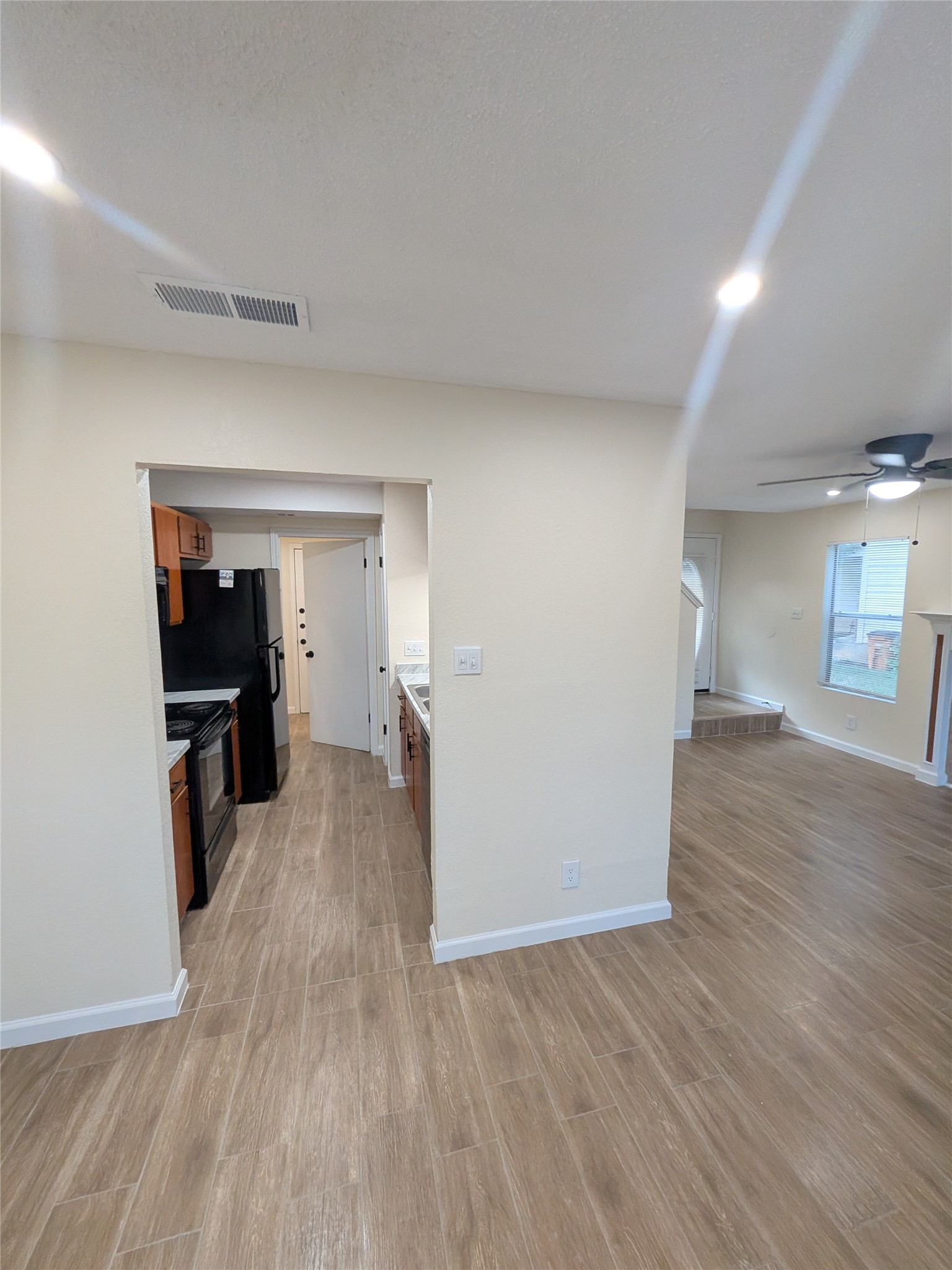 13303 Lyndhurst Street, Unit B Austin, TX 78729 - Photo 5 of 13 Hardwood-style flooring extends from the living area into the functional kitchen.