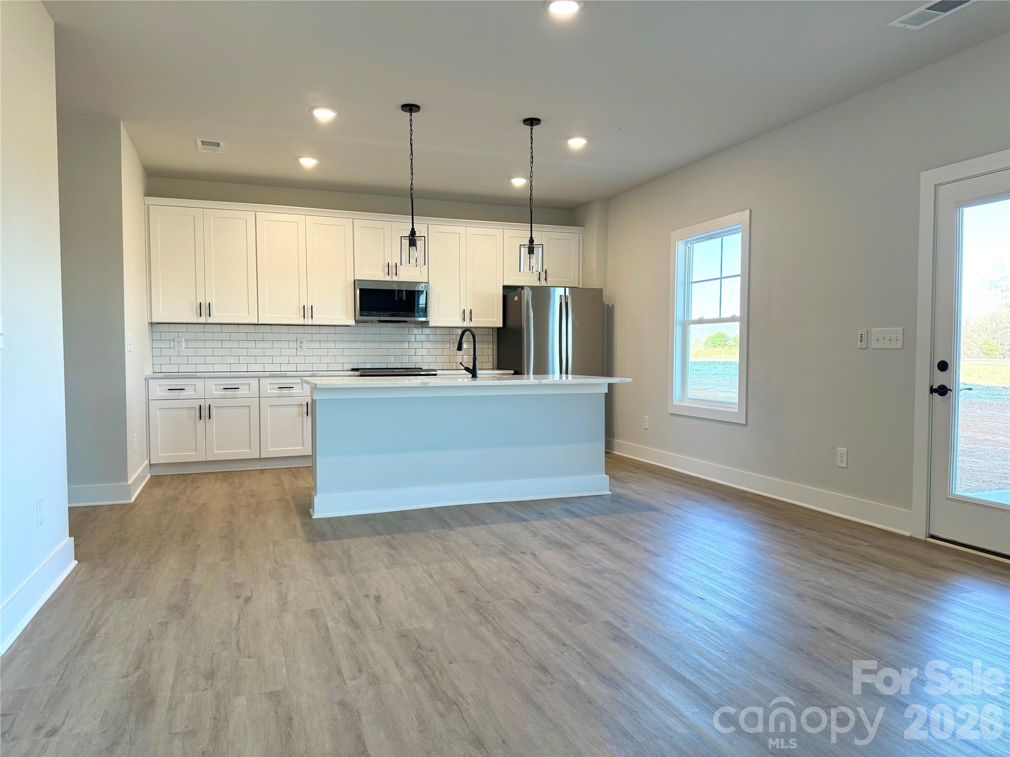 118 Doby Road Mocksville, NC 27028 - Photo 7 of 19 a large kitchen with cabinets wooden floor and a window