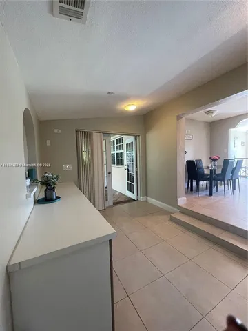 a view of a hallway with a glass door shower