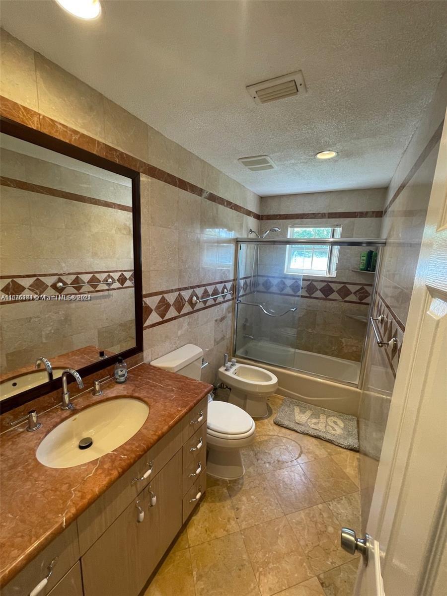 1531 Moffett Street Hollywood, FL 33020 - Photo 13 of 34 a bathroom with a sink double vanity and a mirror