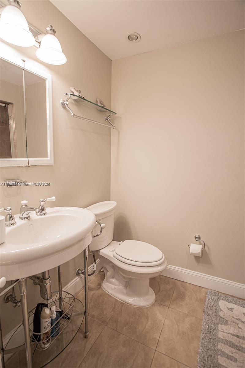 1531 Moffett Street Hollywood, FL 33020 - Photo 19 of 34 a bathroom with a sink a toilet and a mirror