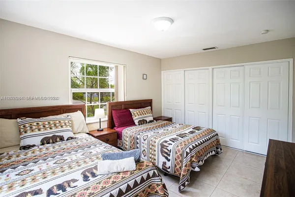 a bedroom with a bed and a dresser in it