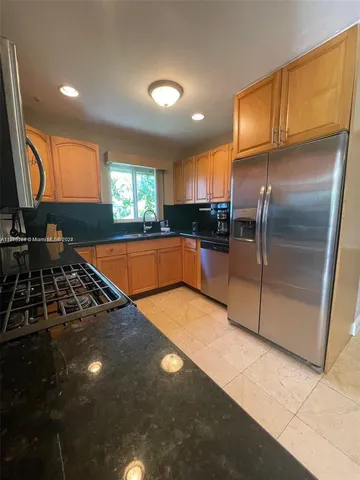a kitchen with stainless steel appliances a sink stove and refrigerator