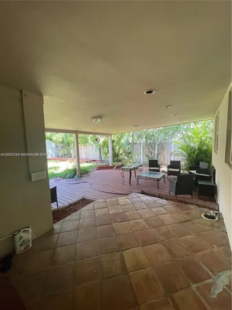 a view of a house with pool and trees in the background