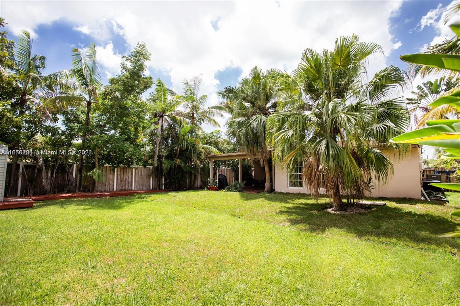 1531 Moffett Street Hollywood, FL 33020 - Photo 32 of 34 a view of a house with a yard and trees