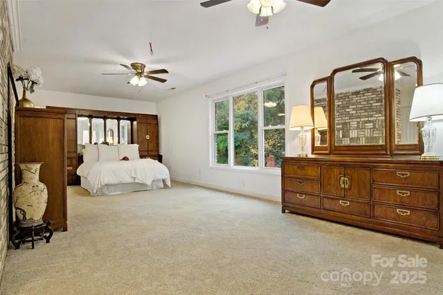 a bedroom with a bed dresser and a window