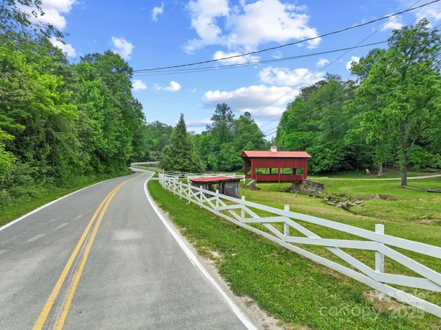 a view of a field with a tree in the background
