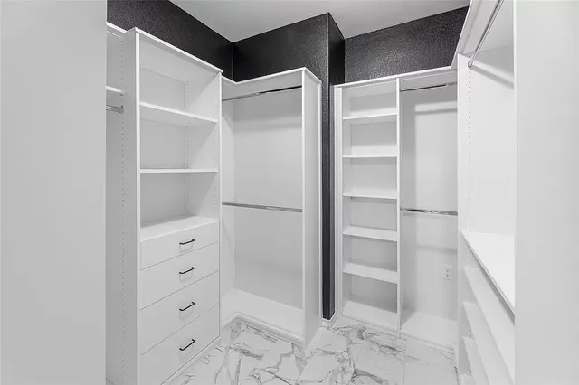 a bathroom with a granite countertop sink toilet a mirror a glass door and shower