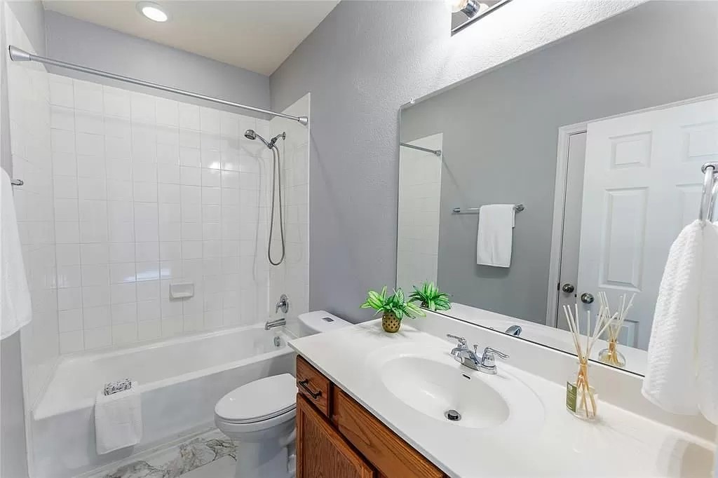 13021 Foreston Drive Austin, TX 78754 - Photo 11 of 17 Full bath with shower / bath combination, vanity, and light marble finish floors