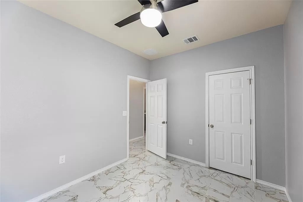 13021 Foreston Drive Austin, TX 78754 - Photo 13 of 17 Unfurnished bedroom featuring light marble finish floors and ceiling fan