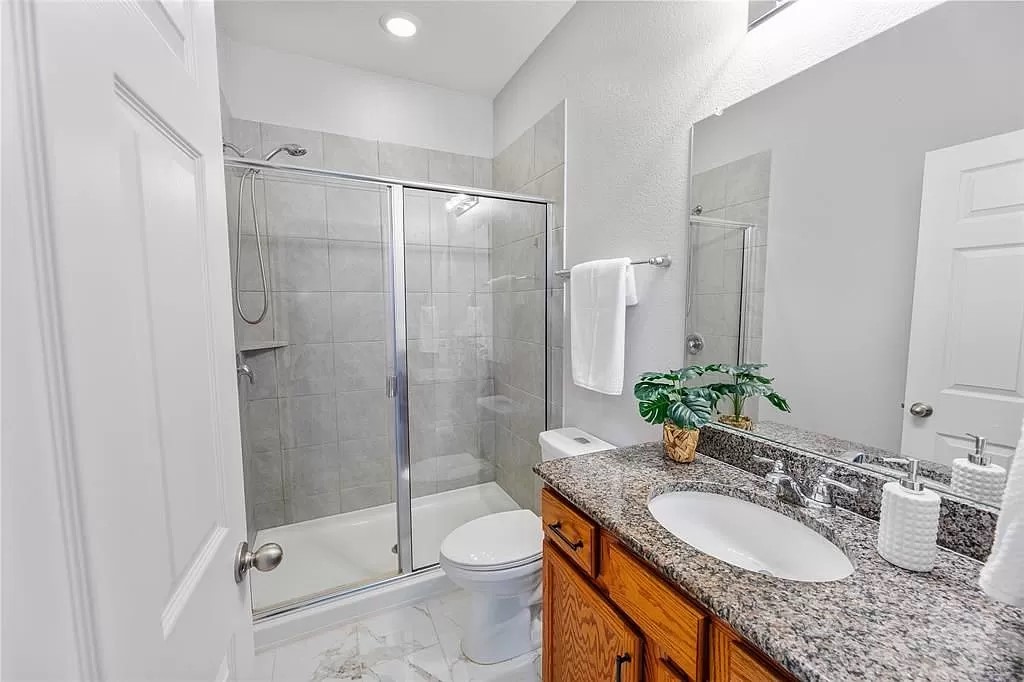 13021 Foreston Drive Austin, TX 78754 - Photo 9 of 17 Full bath with a stall shower, vanity, and light marble finish floors