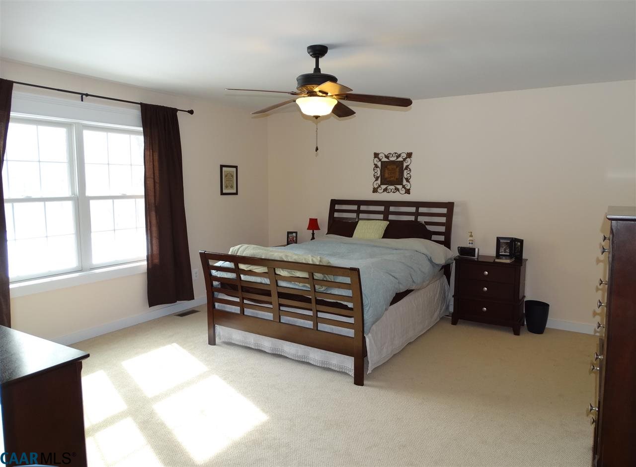 5331 Waterford Road Rixeyville, VA 22737 - Photo 18 of 36 a bedroom with a bed and a chandelier