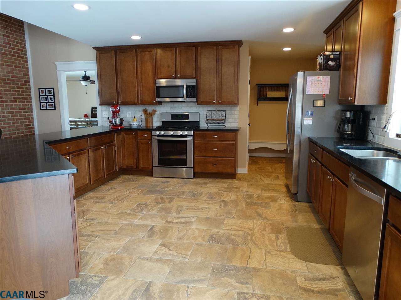 5331 Waterford Road Rixeyville, VA 22737 - Photo 9 of 36 a kitchen with stainless steel appliances granite countertop a stove refrigerator sink and microwave