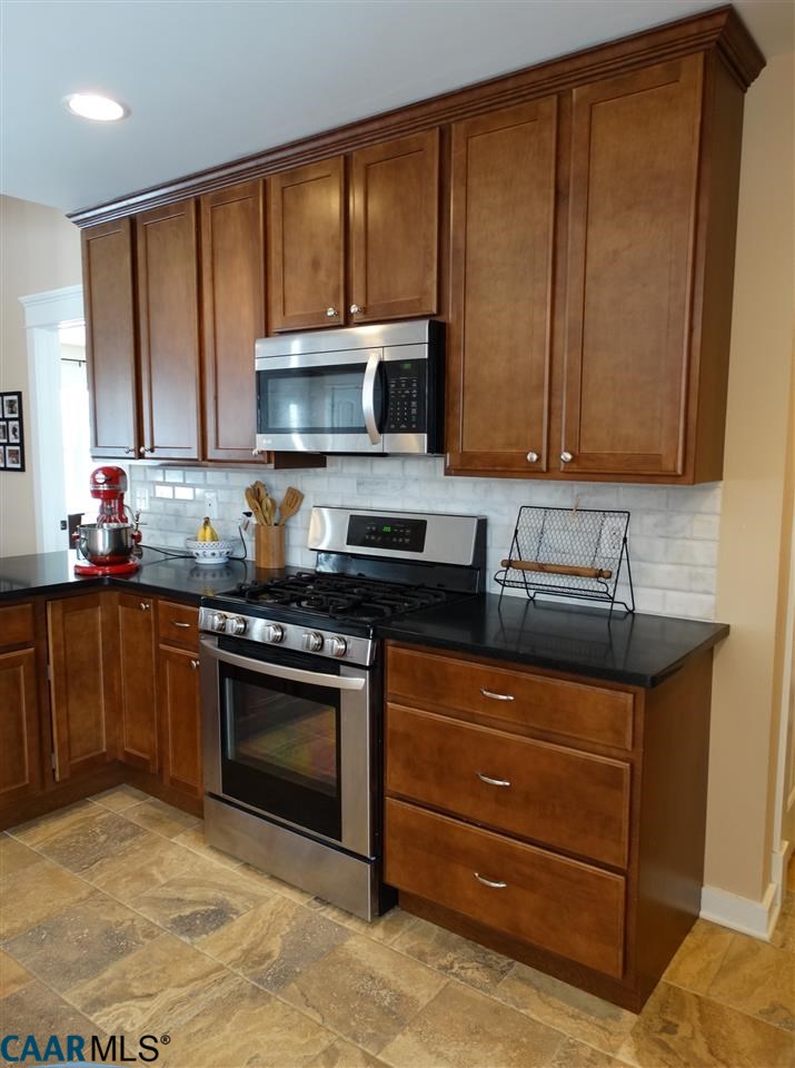5331 Waterford Road Rixeyville, VA 22737 - Photo 10 of 36 a kitchen with stainless steel appliances granite countertop a stove a sink and a microwave