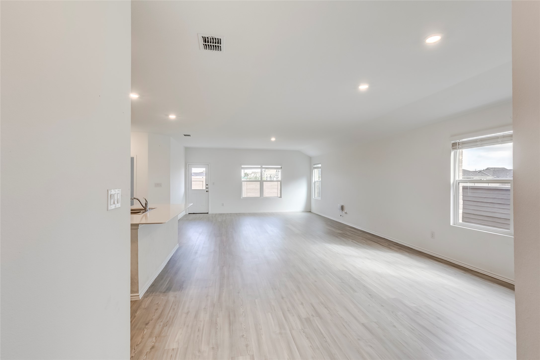 591 Avre Loop Kyle, TX 78640 - Photo 6 of 34 an empty room with wooden floor and windows