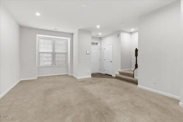 an empty room with windows and pillars in it