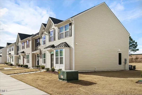 a view of a white building among the street and a building