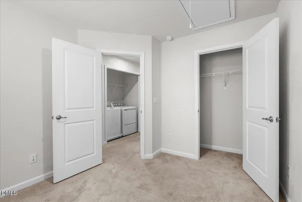 an empty room with a bathroom and a sink