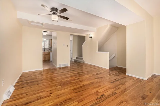 a view of an empty room with wooden floor