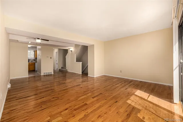 a view of empty room with wooden floor