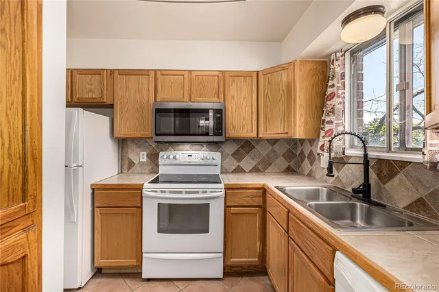a kitchen with a stove a sink and a microwave