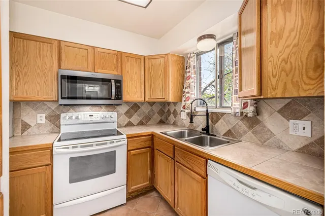 a kitchen with a stove microwave and sink