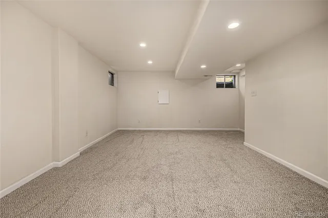 an empty room with a empty space and windows