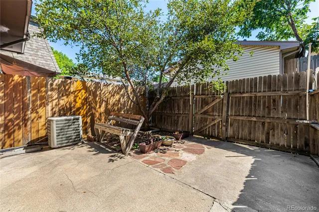 a view of a backyard with a wooden fence