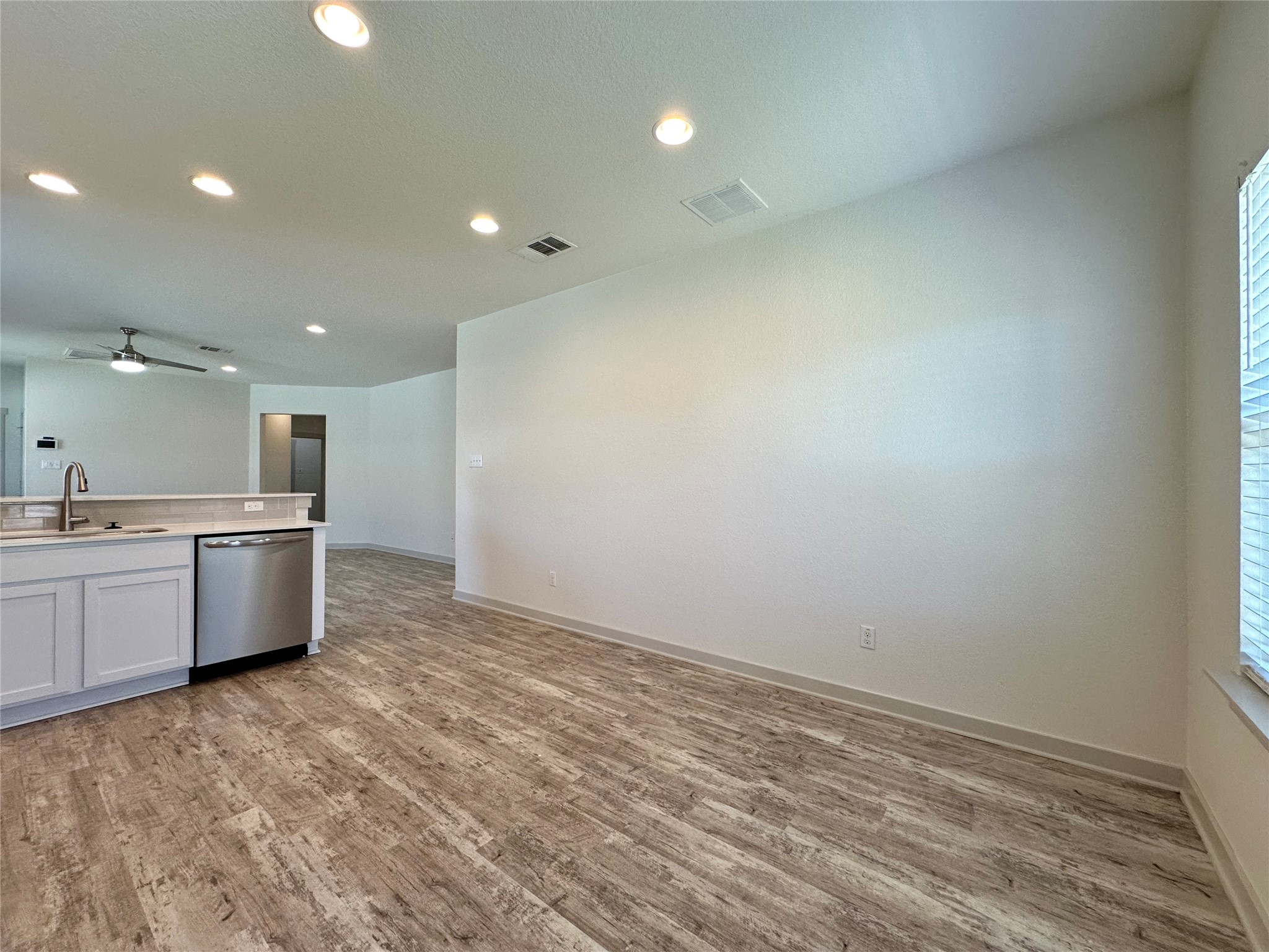 5132 Vanner Path Georgetown, TX 78626 - Photo 12 of 37 Kitchen with white cabinetry, ceiling fan, stainless steel dishwasher, light wood-style floors, and recessed lighting