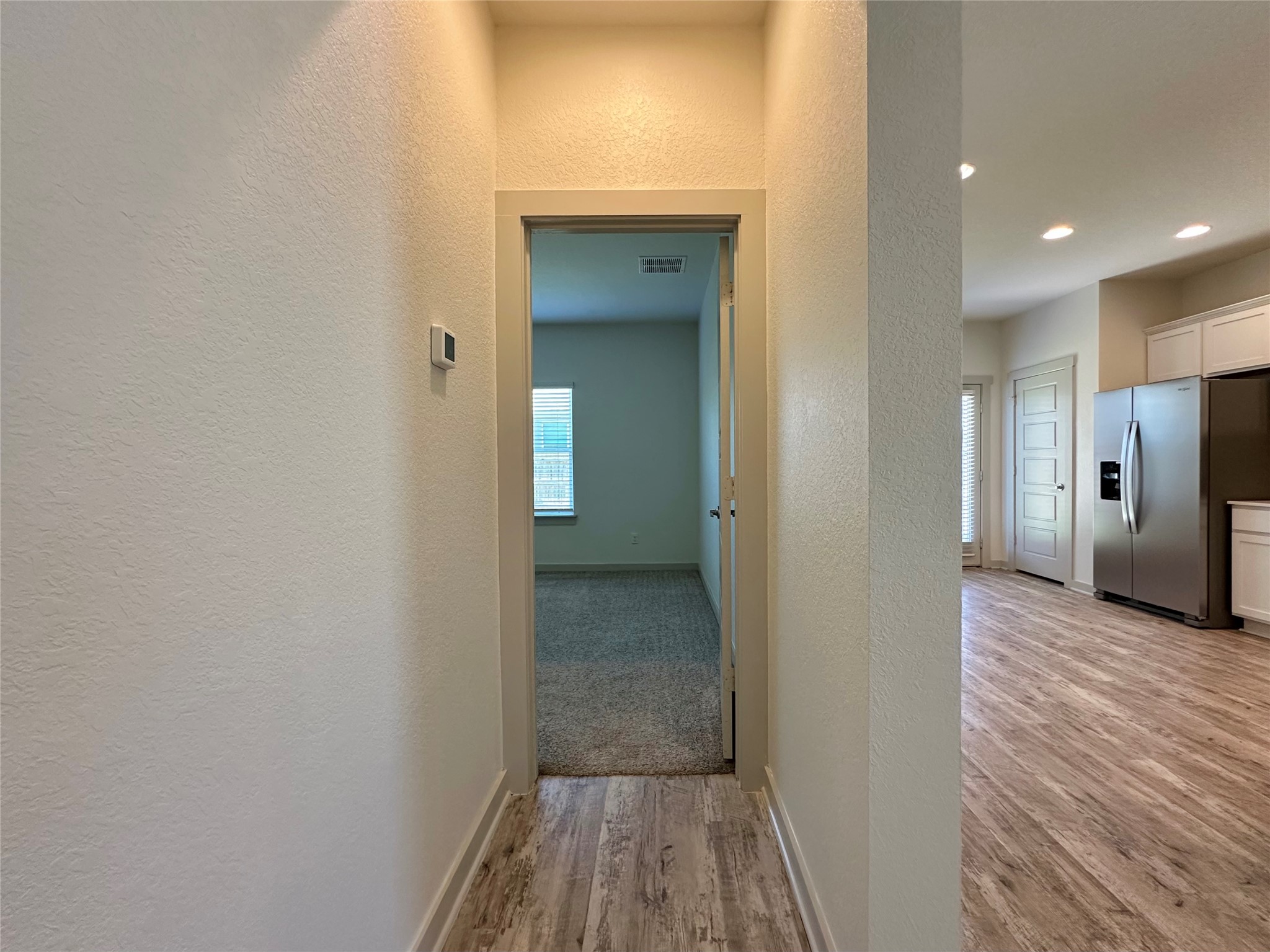 5132 Vanner Path Georgetown, TX 78626 - Photo 13 of 37 Corridor featuring light wood-type flooring, a textured wall, and recessed lighting