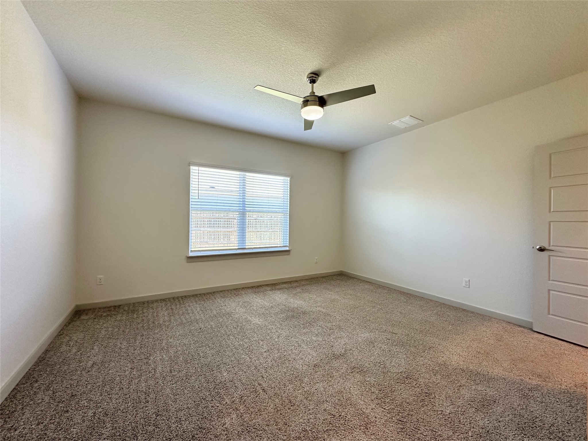 5132 Vanner Path Georgetown, TX 78626 - Photo 18 of 37 Carpeted empty room featuring a textured ceiling and a ceiling fan