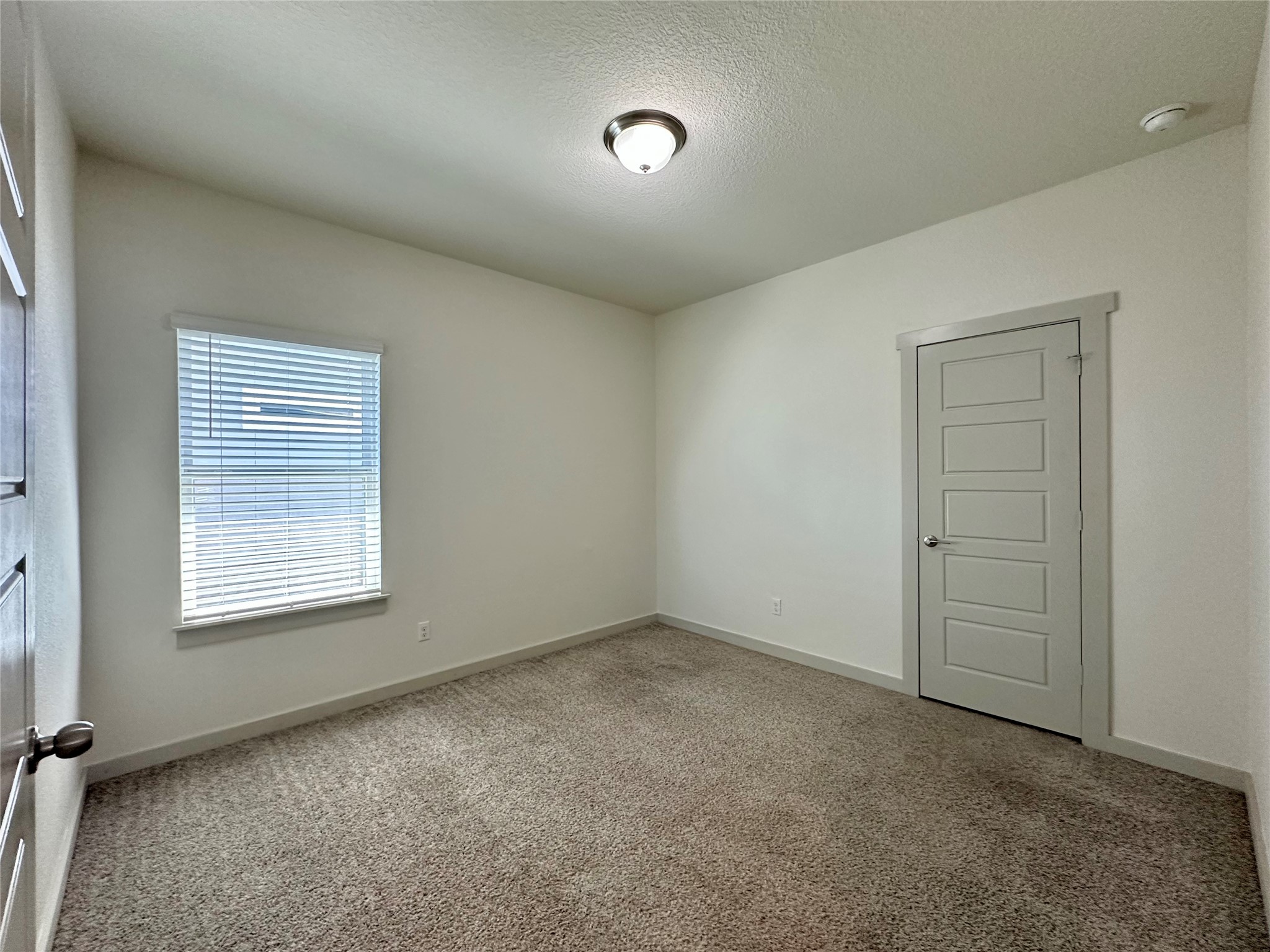 5132 Vanner Path Georgetown, TX 78626 - Photo 21 of 37 Carpeted empty room with baseboards and a textured ceiling