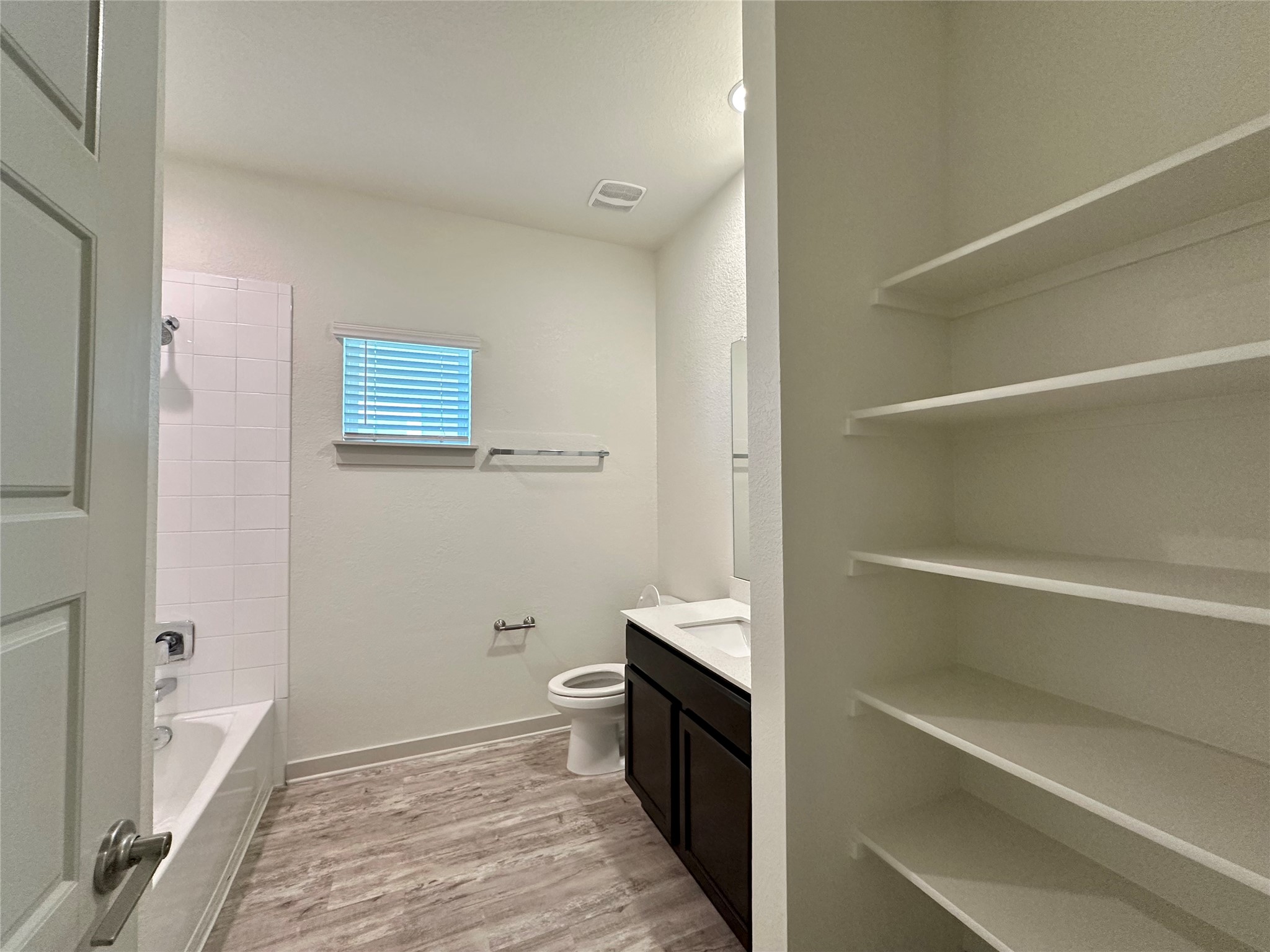 5132 Vanner Path Georgetown, TX 78626 - Photo 23 of 37 Full bath with vanity, light wood-type flooring, and shower / bathtub combination
