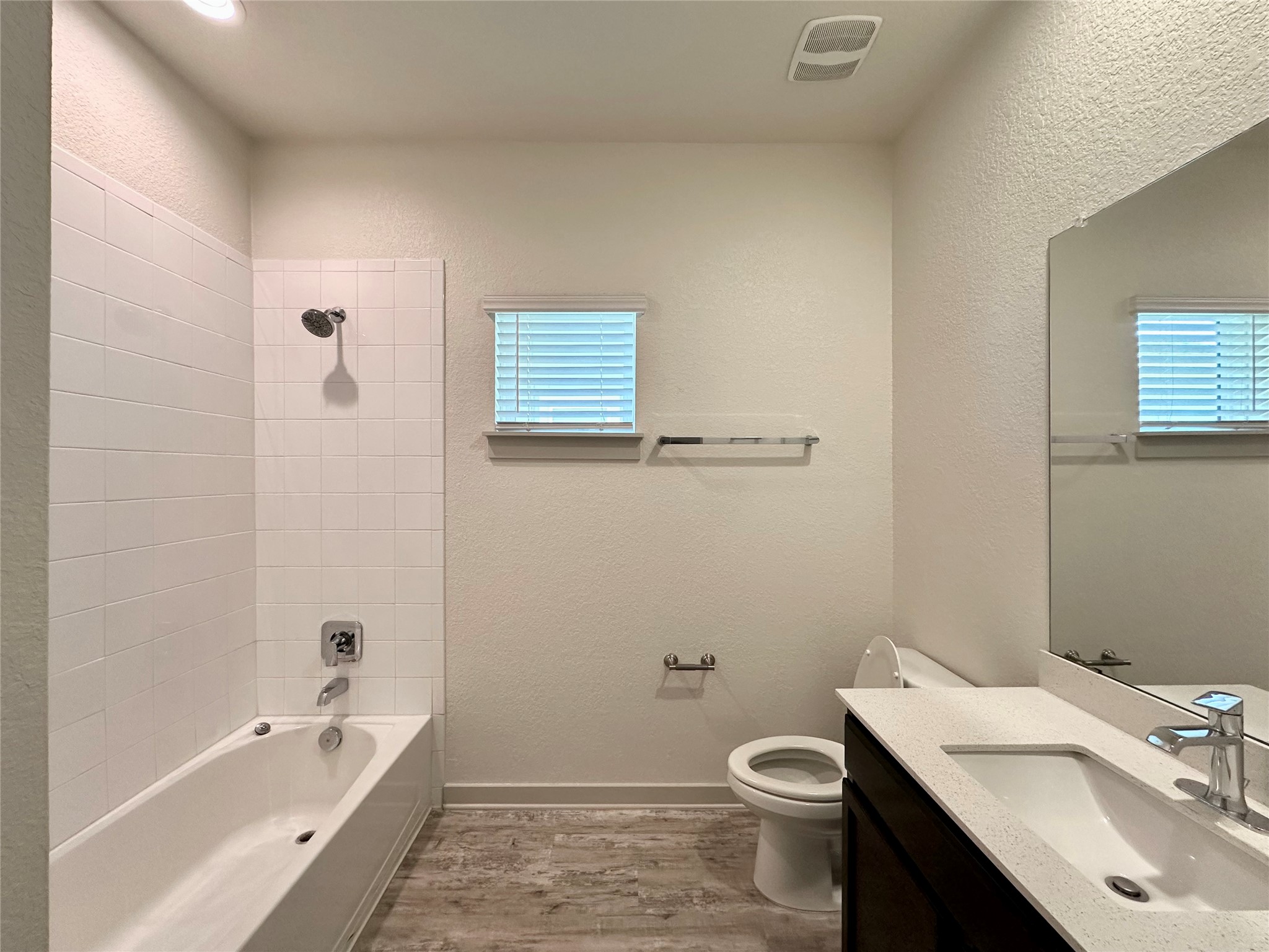 5132 Vanner Path Georgetown, TX 78626 - Photo 24 of 37 Bathroom featuring vanity, a textured wall, light wood-style flooring, and tub / shower combination