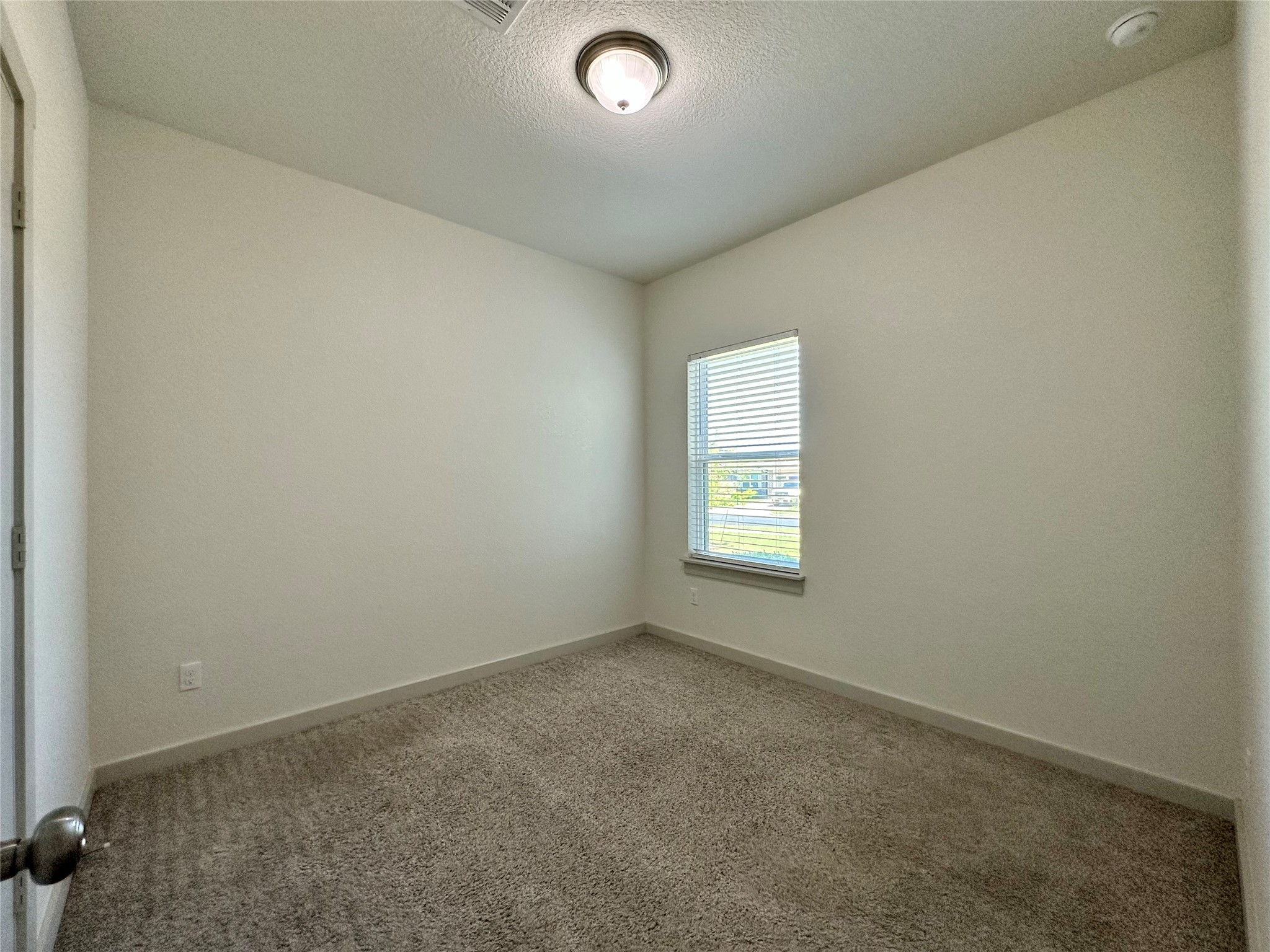 5132 Vanner Path Georgetown, TX 78626 - Photo 27 of 37 Carpeted empty room featuring baseboards and a textured ceiling