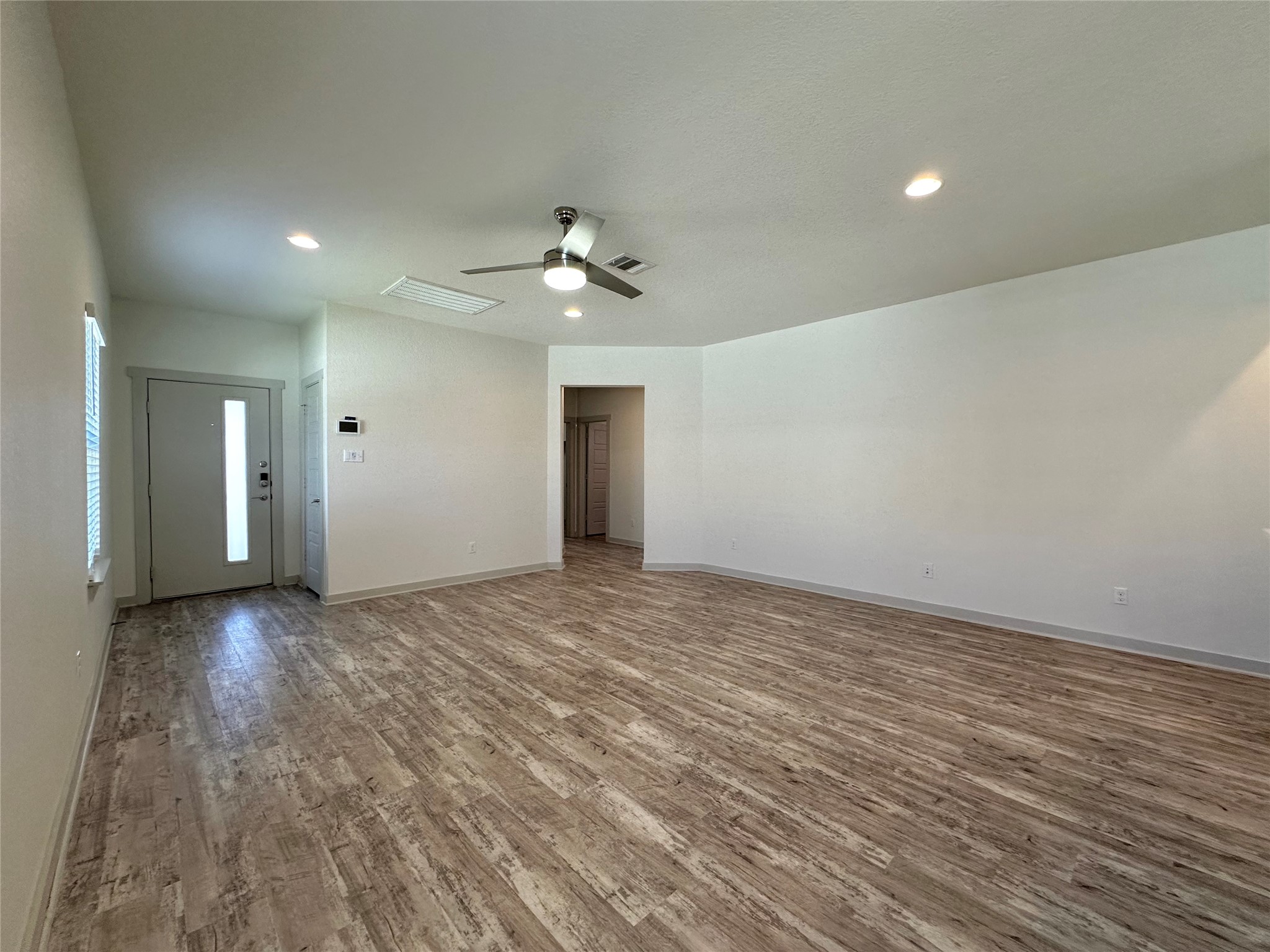 5132 Vanner Path Georgetown, TX 78626 - Photo 31 of 37 Unfurnished living room with wood finished floors, ceiling fan, and recessed lighting