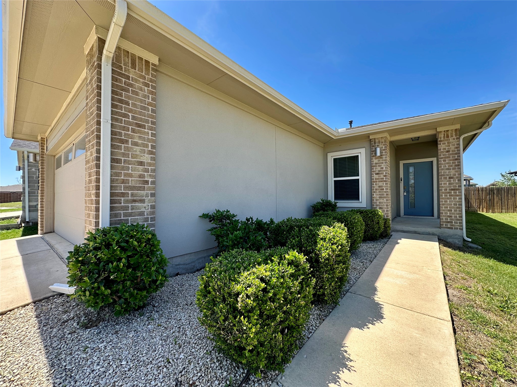 5132 Vanner Path Georgetown, TX 78626 - Photo 4 of 37 Entrance to property featuring brick siding, a garage, driveway, and stucco siding