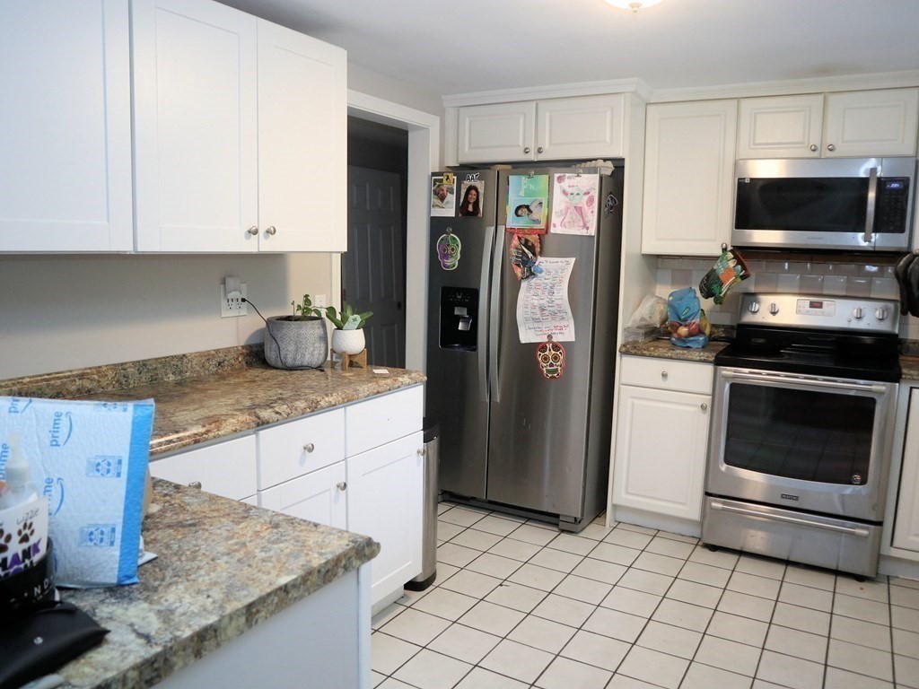 12 Tecumseh Road Bourne, MA 02562 - Photo 3 of 36 a kitchen with stainless steel appliances granite countertop a refrigerator stove and sink