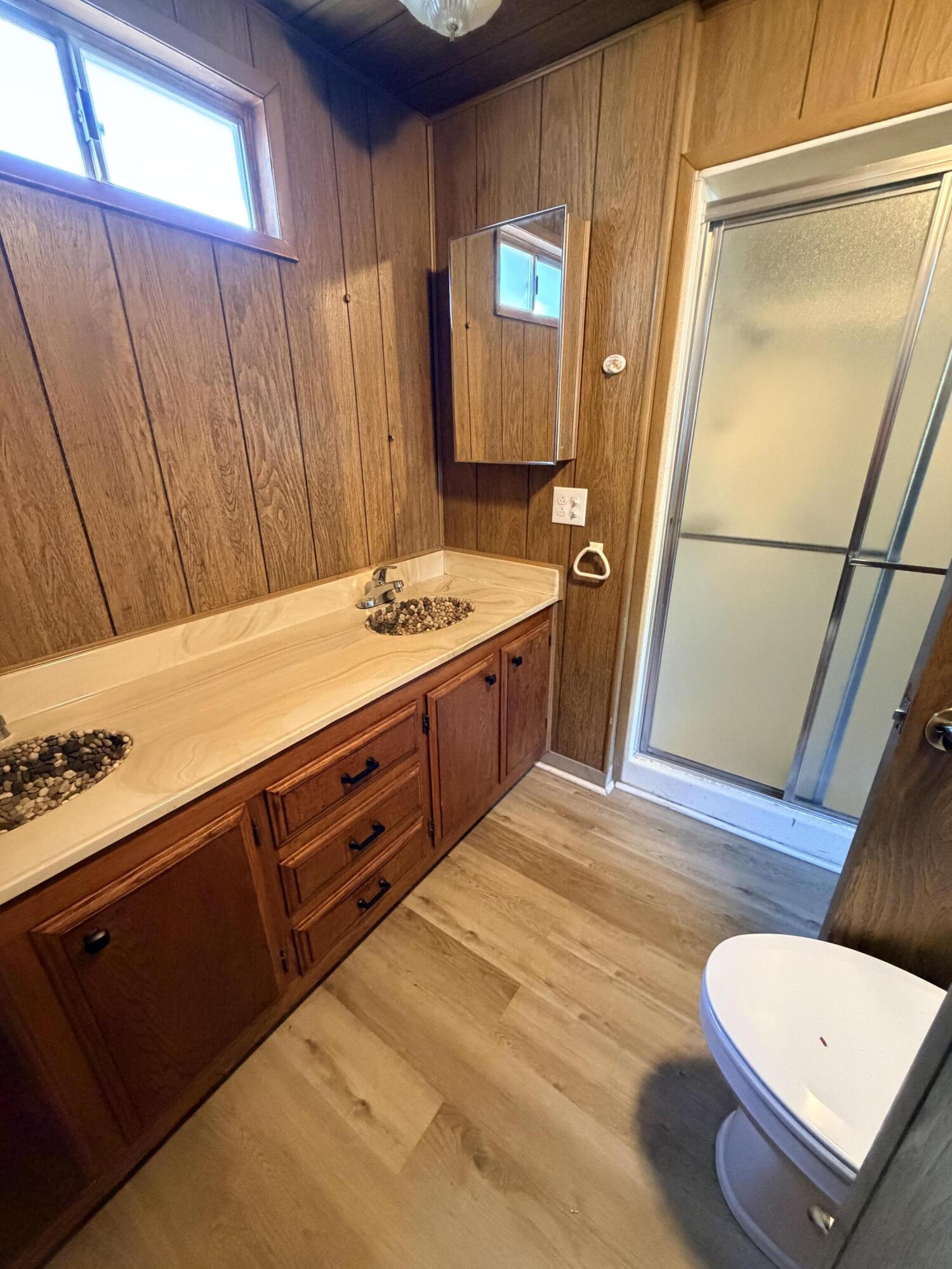 1449 Menomenee Lane, Unit 252 Redding, CA 96003 - Photo 14 of 18 a bathroom with a sink a mirror and a toilet