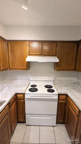 a kitchen with a refrigerator sink and cabinets