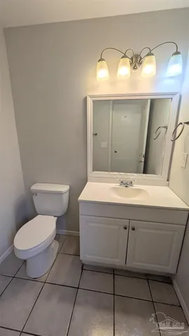 a bathroom with a toilet and a mirror