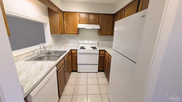 a kitchen with granite countertop cabinets and sink